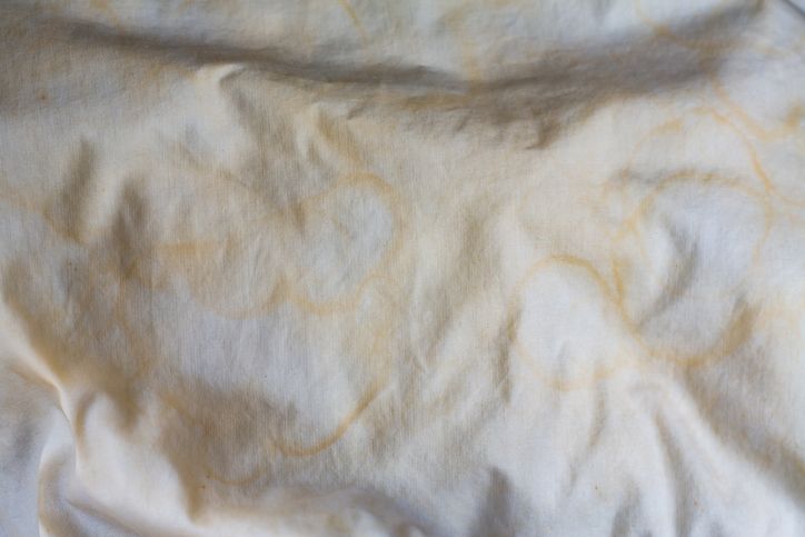 Sheets with yellow sweat stains