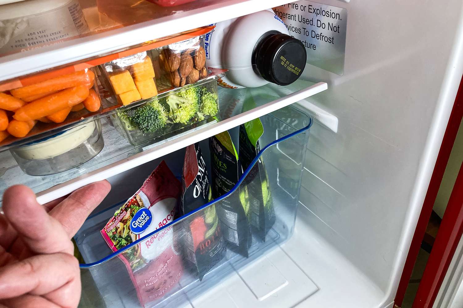 Interior of West Bend Mini Fridge showing various food items organized on shelves including vegetables snacks and drinks