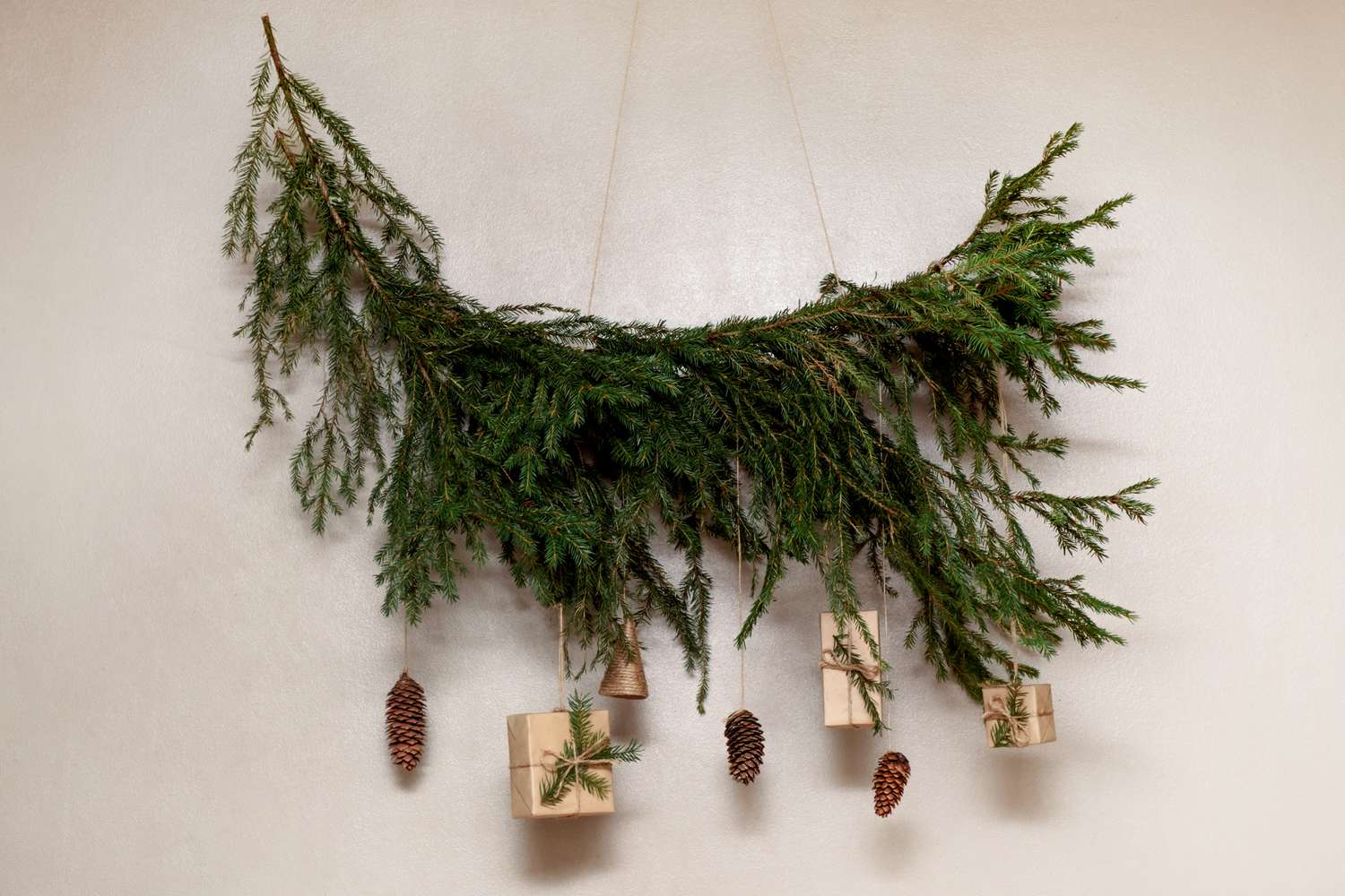A fir branch with hanging wrapped gifts