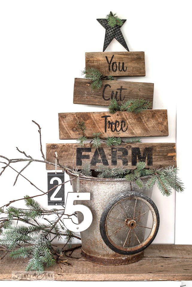 A wood tree farm sign made into the shape of a Christmas tree