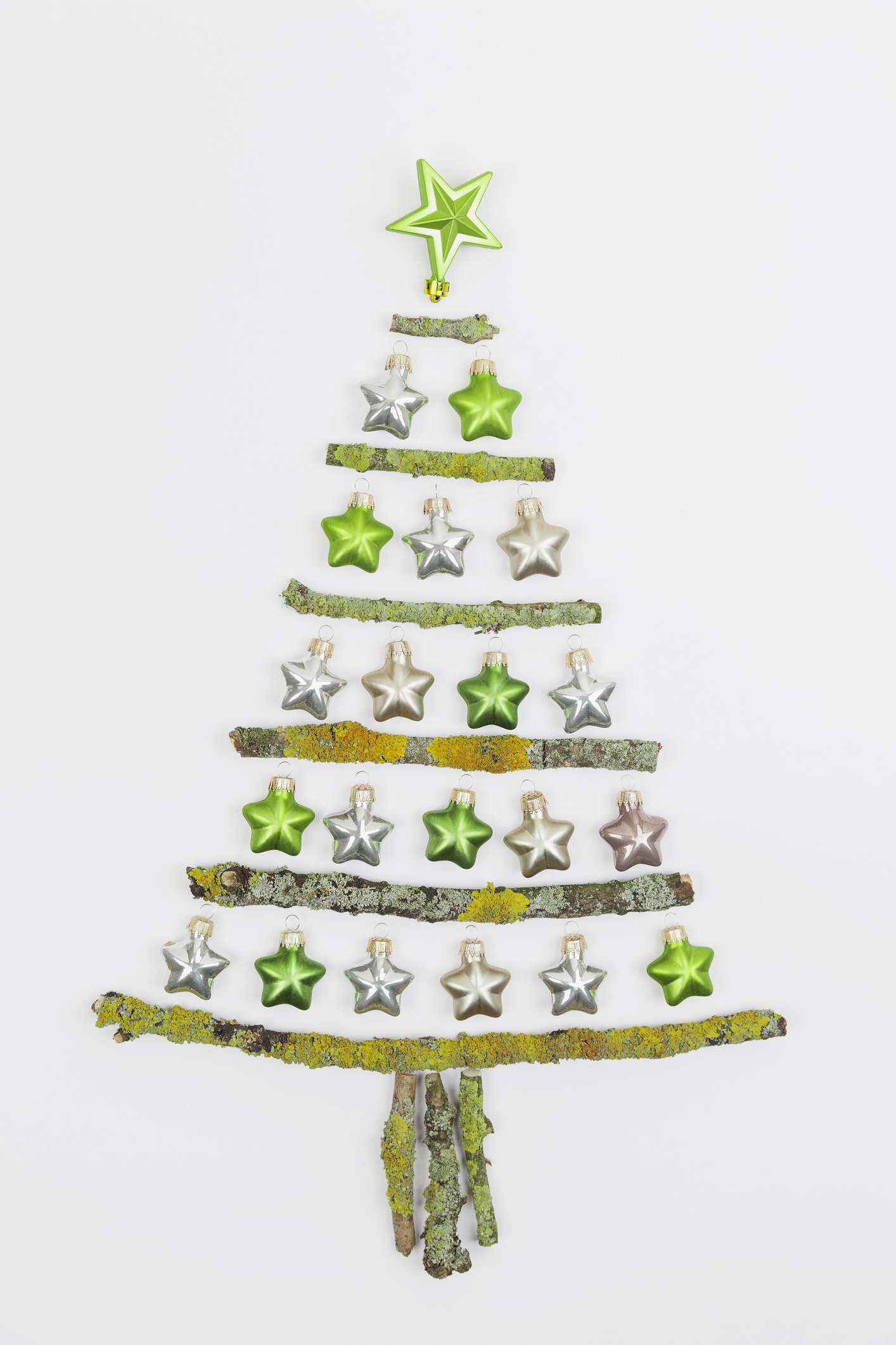Mossy branches and ornaments shaped into a Christmas tree