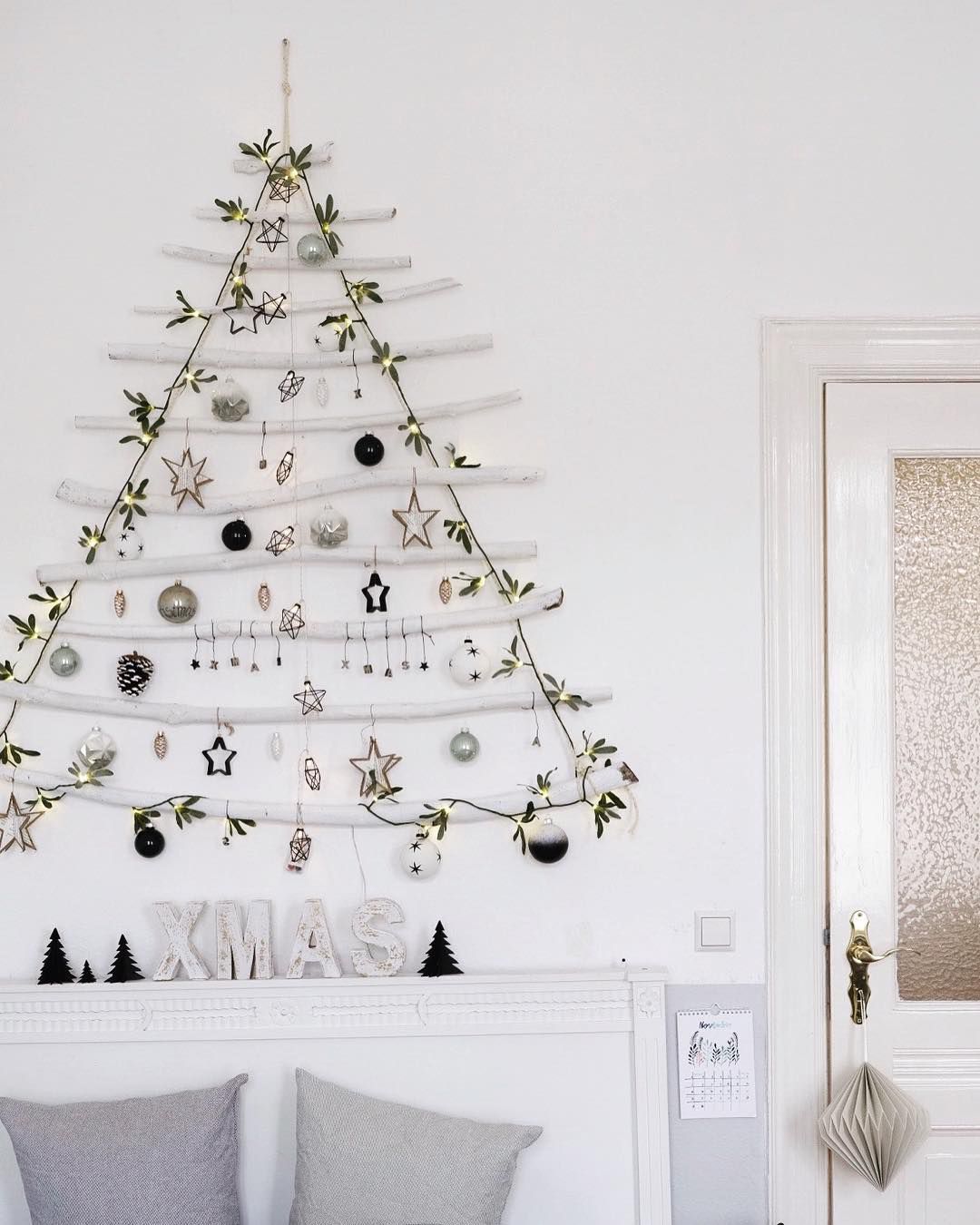 A hanging DIY tree with white branches and lights