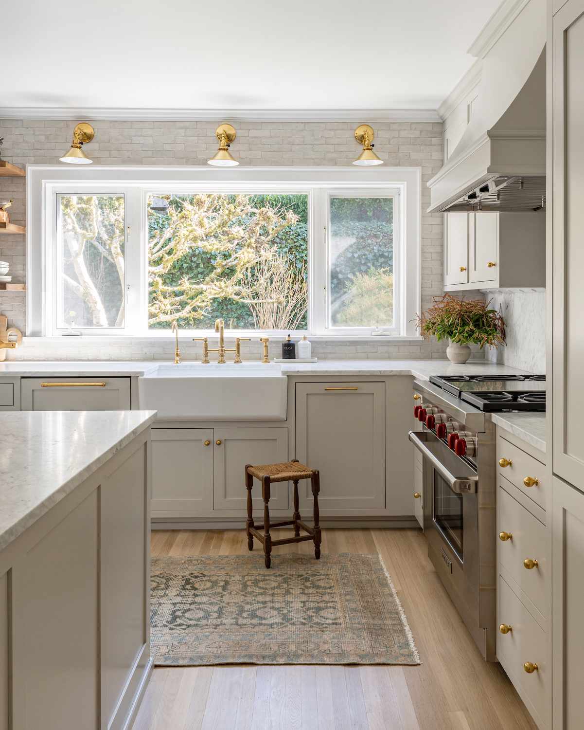 kitchen sink window with brass sconces