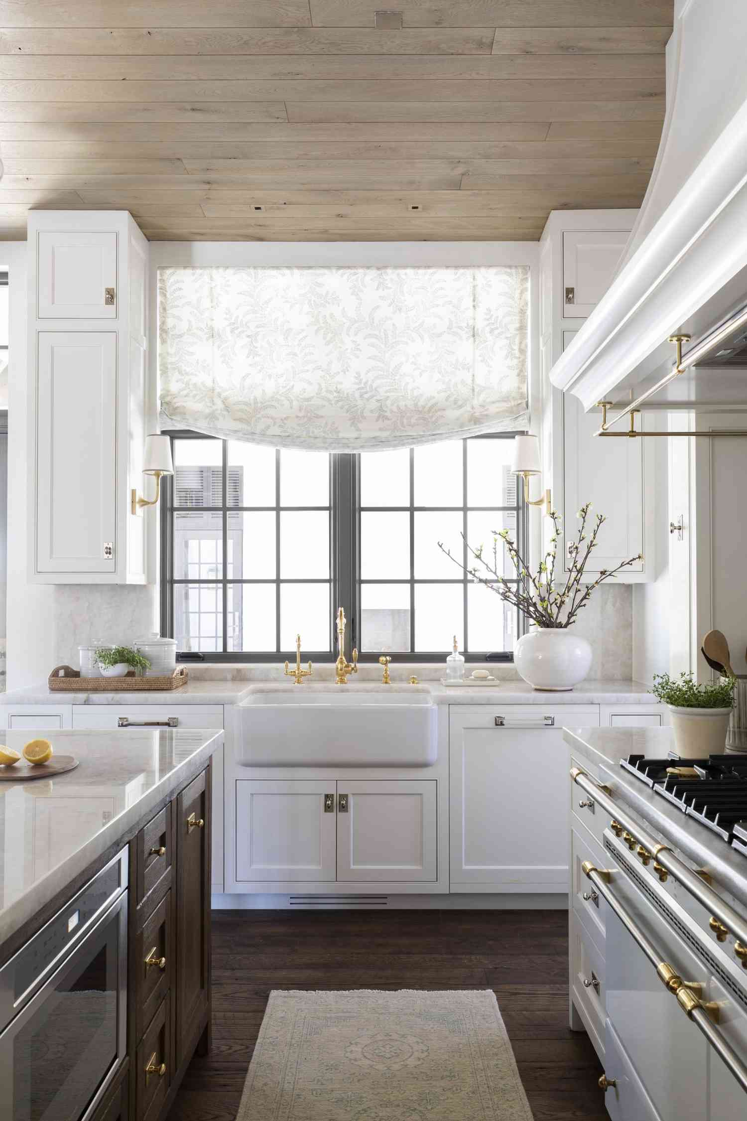patterned roman shade over kitchen sink window