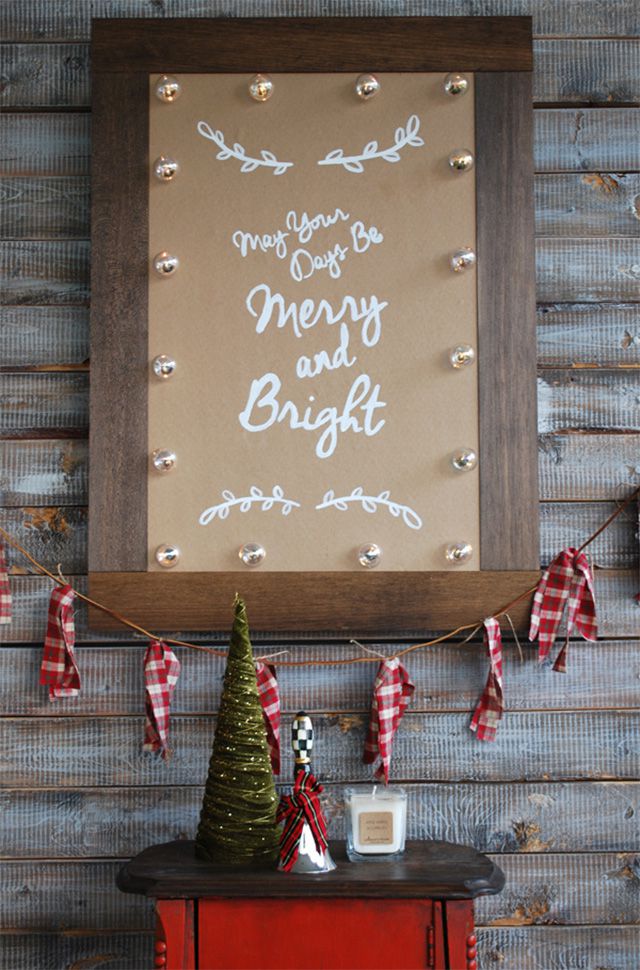 A DIY Christmas signs lit up with lights