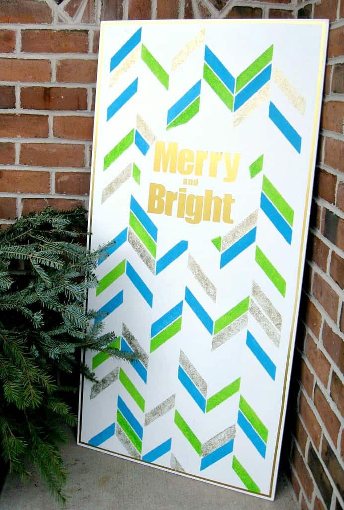 A blue, green, and gold DIY Christmas sign