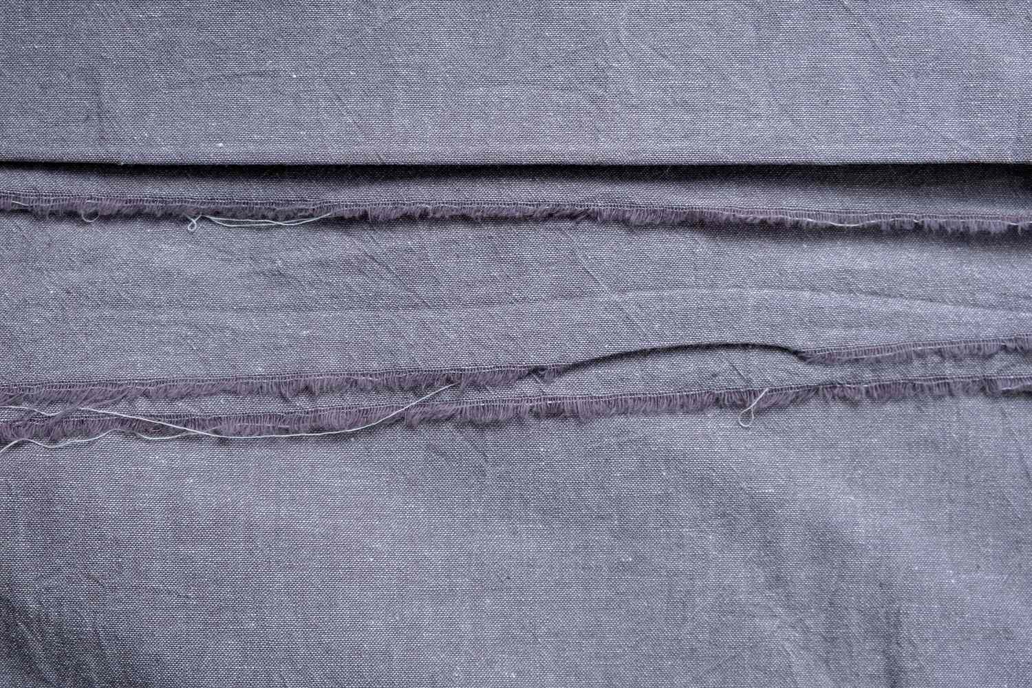 Ripped seams on a linen fabric.