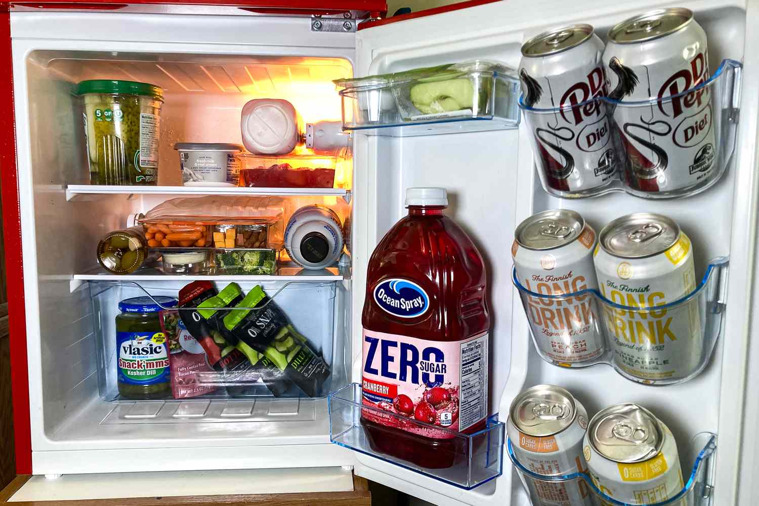 My Retro Mini Fridge Has a Freezer And Is Perfect for Dorm Rooms or Your Home Office 4 The West Bend Mini Fridge with Freezer with various beverages snacks and food items inside